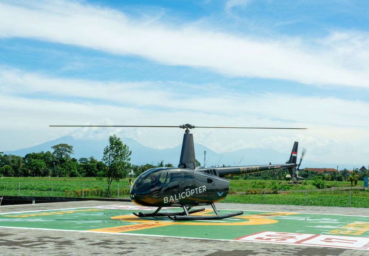 Robinson R66 at rest with the mountains behind